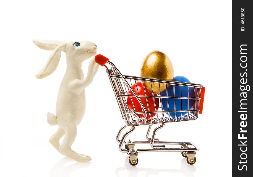 Easter rabbit carries the cart with multi-coloured eggs. Easter rabbit carries the cart with multi-coloured eggs