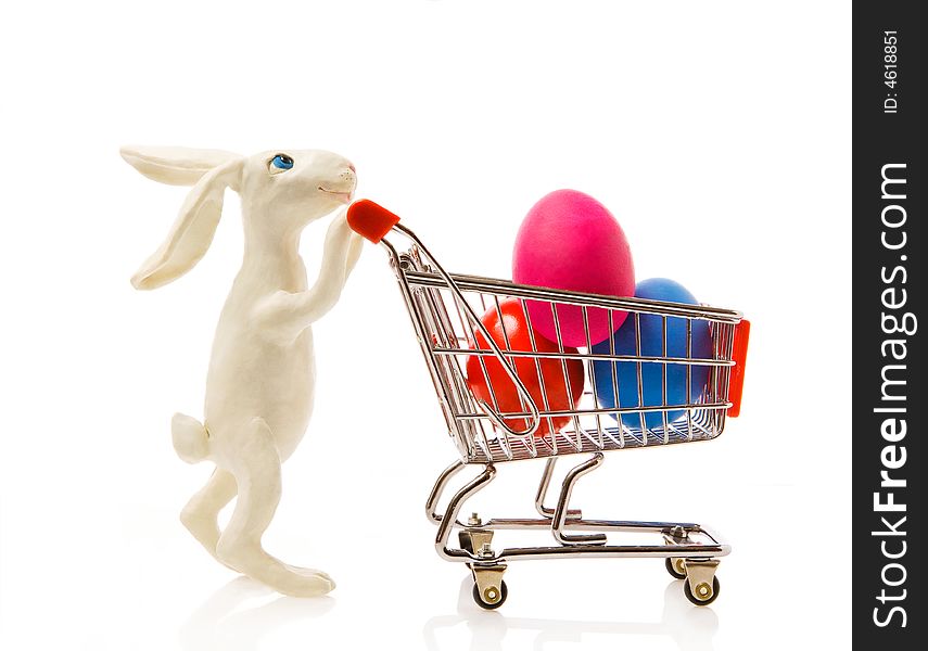 Easter rabbit carries the cart with multi-coloured eggs. Easter rabbit carries the cart with multi-coloured eggs