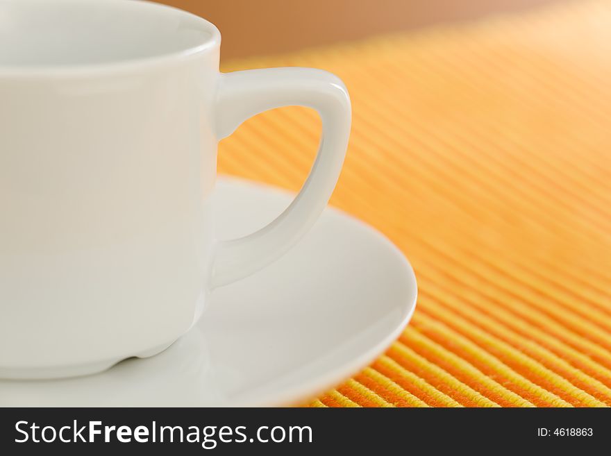 Empty coffee on orange - yellow striped fabric. Empty coffee on orange - yellow striped fabric