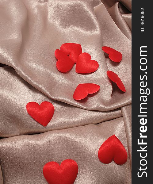 Hearts on the satin background