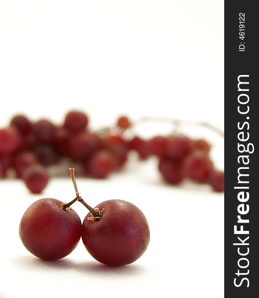 Image of two joined grapes on white background. Vertical orientation. Image of two joined grapes on white background. Vertical orientation.