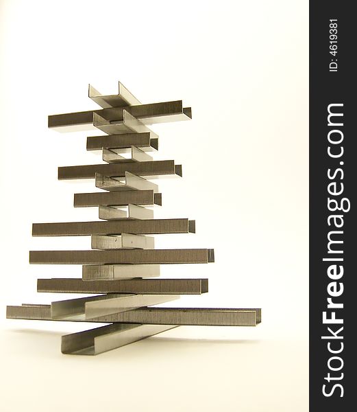 Full image of a structure made of replacement staples.  White background and vertical orientation. Full image of a structure made of replacement staples.  White background and vertical orientation.