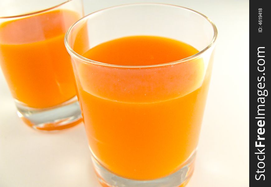 Glass of juice on white background