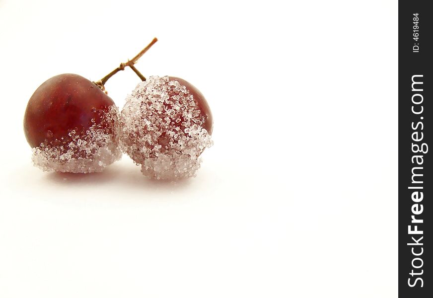 Image of two grapes joined together, dipped in granulated white sugar.  Horizontal orientation. Image of two grapes joined together, dipped in granulated white sugar.  Horizontal orientation.