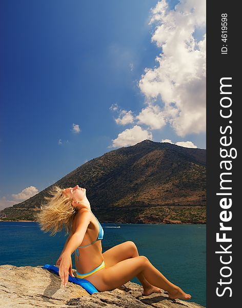 Beautiful girl relaxing near the sea