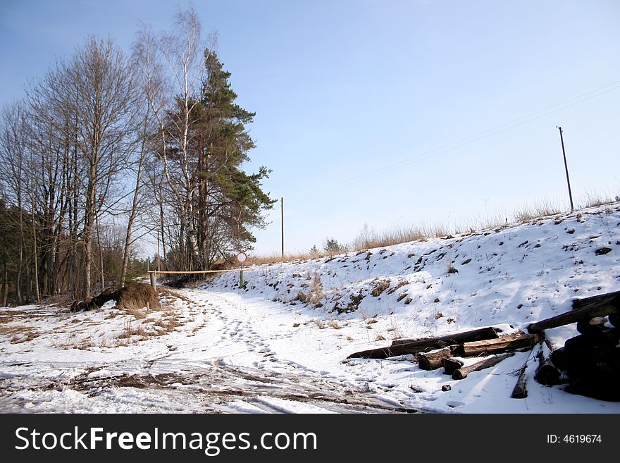 Spring rural picture: a hill, trees a snow and the sky. Spring rural picture: a hill, trees a snow and the sky