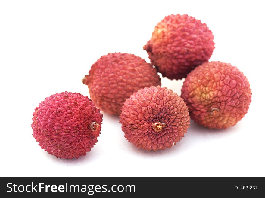 Five colorful lychees isolated on a white background. Five colorful lychees isolated on a white background.