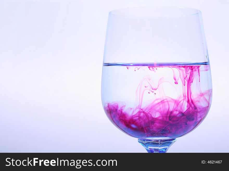 Coloured varicoloured wineglasses with reflections and red liquid. Coloured varicoloured wineglasses with reflections and red liquid