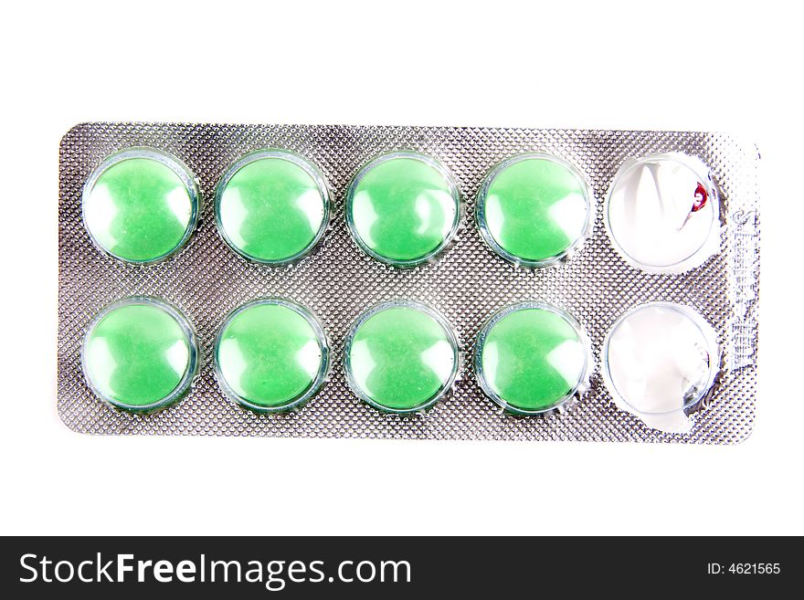 Green pills isolated on the white background