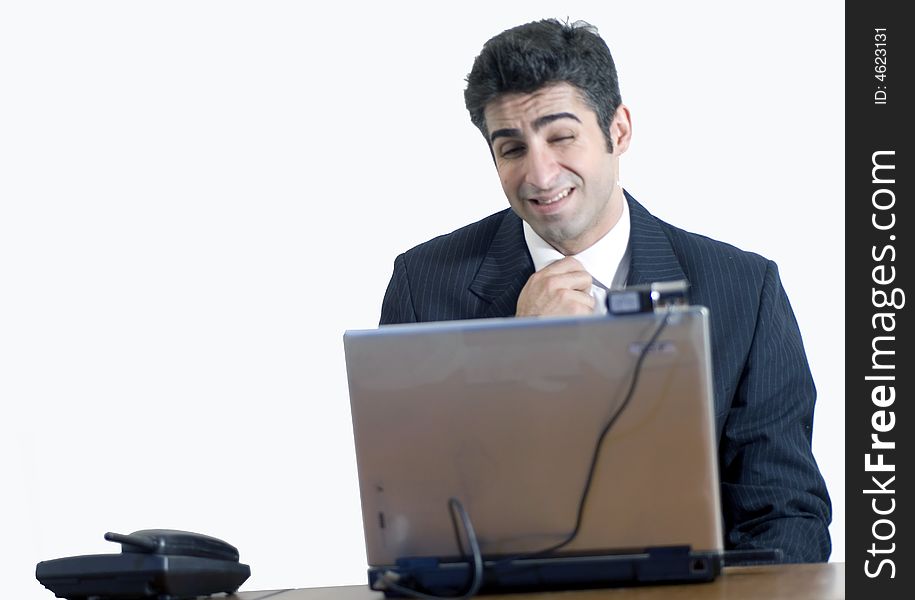 Tired businessman at his laptop. Isolated against a white background. Tired businessman at his laptop. Isolated against a white background