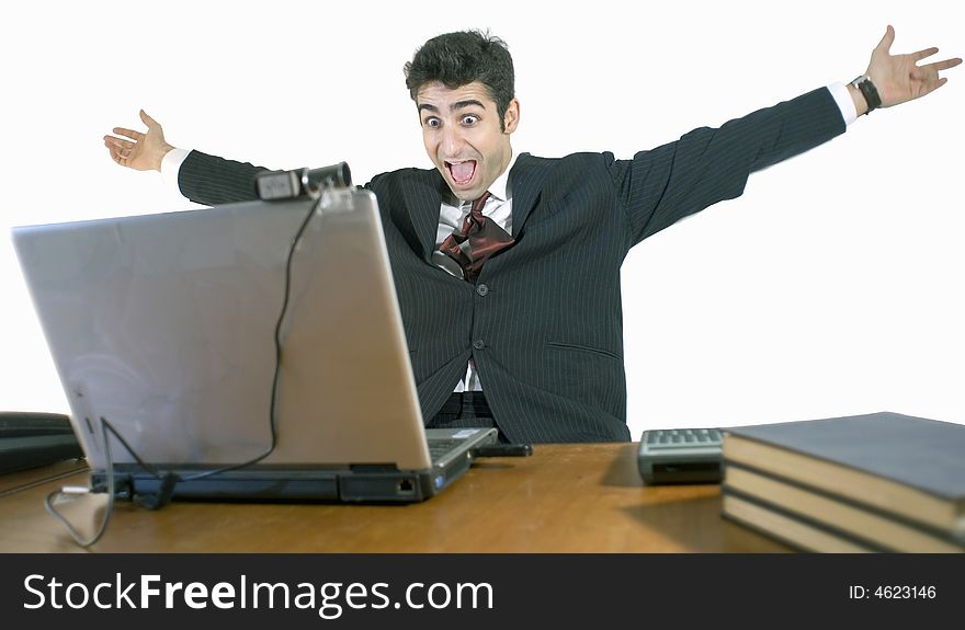 Business man with his arms outstretched sitting at this laptop. Isolated against a white background. Business man with his arms outstretched sitting at this laptop. Isolated against a white background