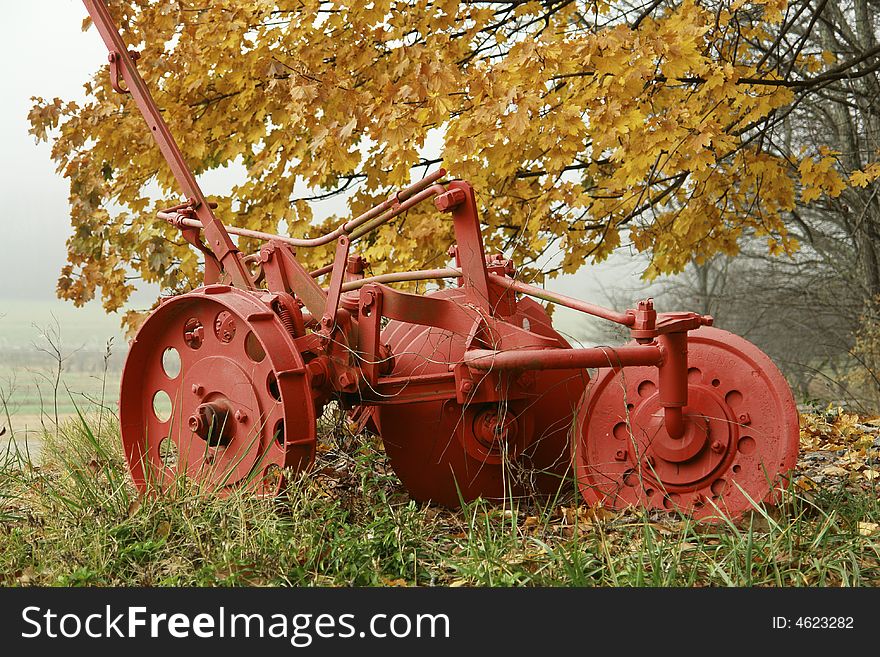 Old plow in the autumn mist