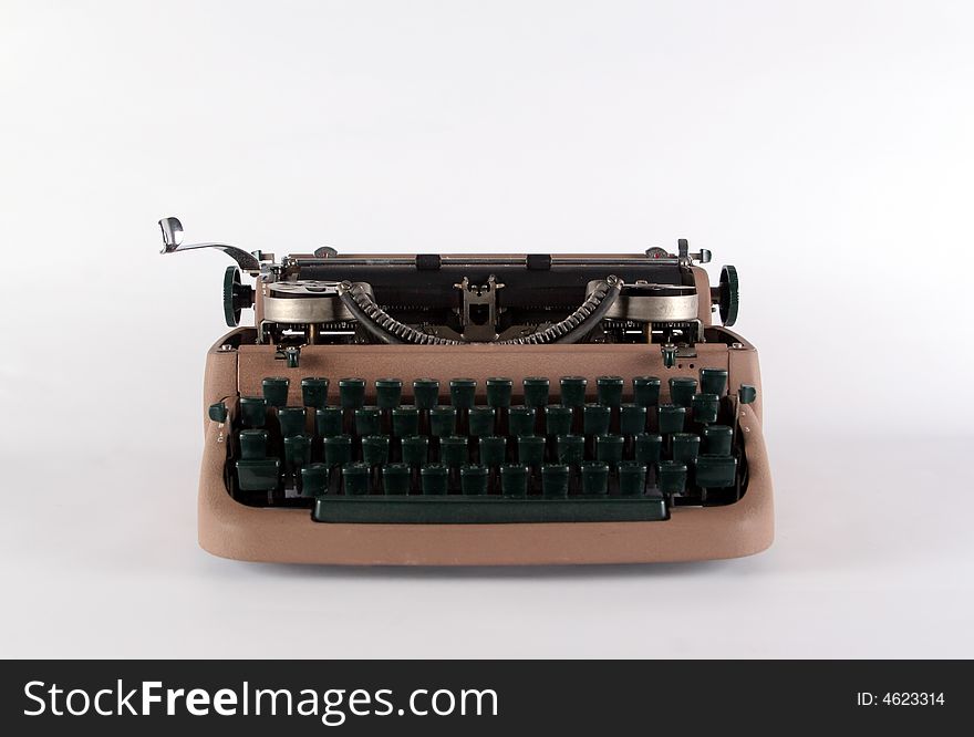 Typewriter isolated on white, full front view showing keys and ribbon spools. Typewriter isolated on white, full front view showing keys and ribbon spools