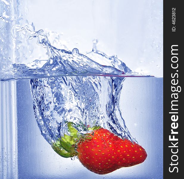 Splashing strawberry into a water. Splashing strawberry into a water