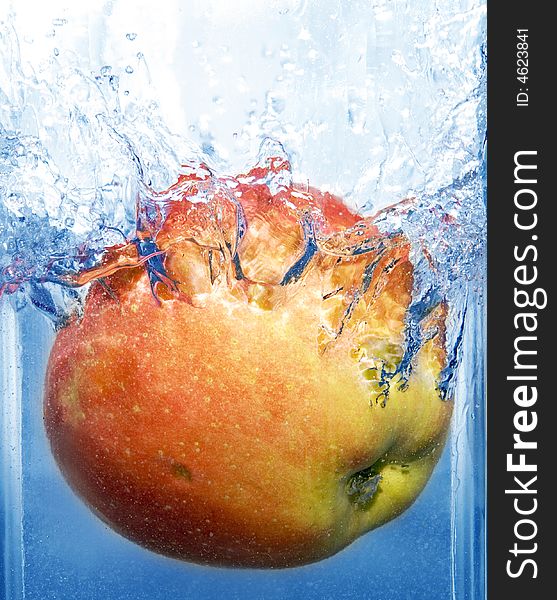 Splashing apple into a water