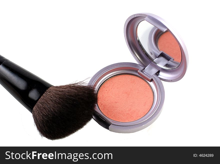 Pink blush with brush on a white background