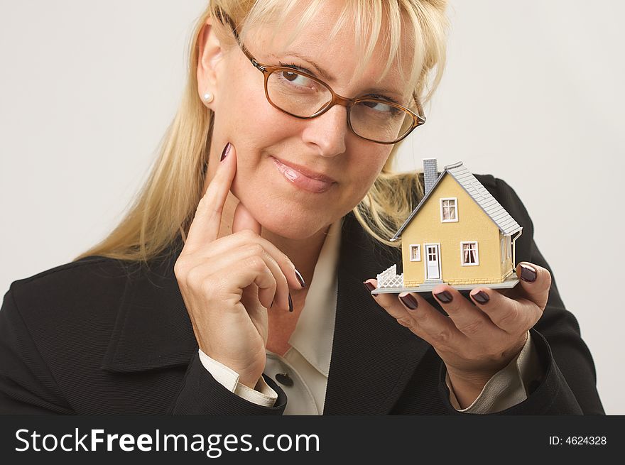 Female holding small house - making a decision. Female holding small house - making a decision.