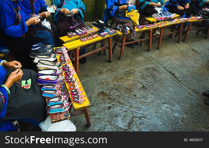 Miao national minority's old women is Sewing her national clothing in China