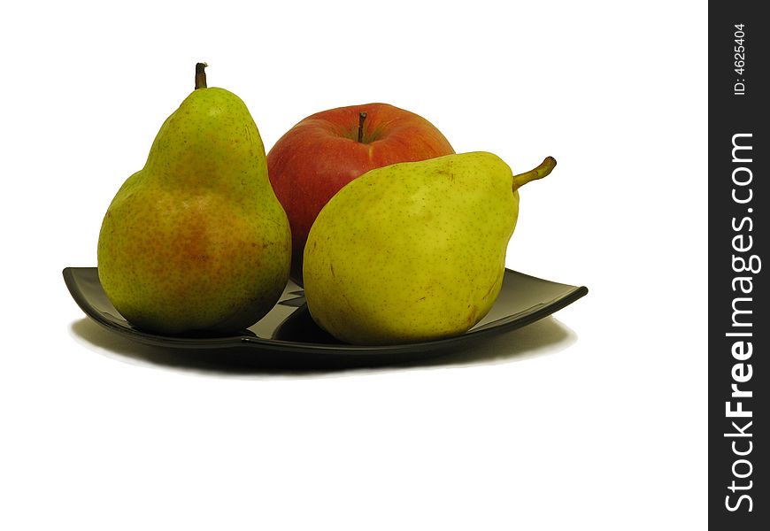Two pears and apple on black dish isolated on white