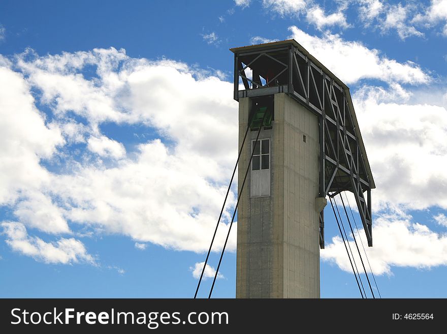 A cable-car with a blue sky in the background. A cable-car with a blue sky in the background