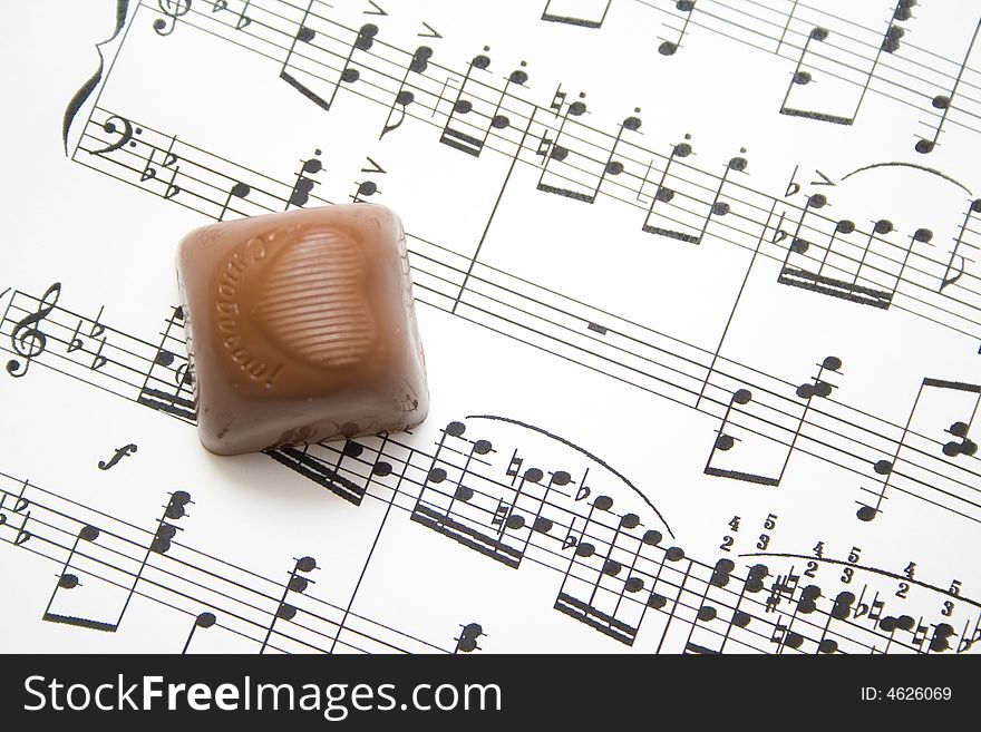 Musical notes and chocolate background. Musical notes and chocolate background