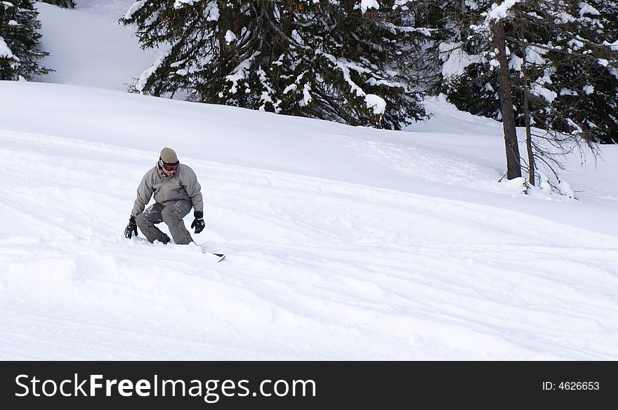 Snowboarder guy sliding off the slope.