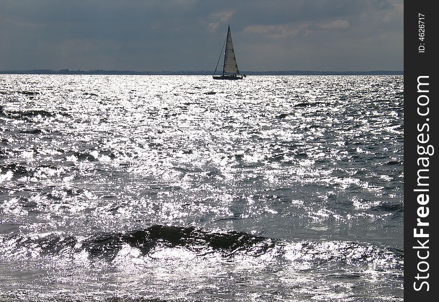 Sailboat in sunset - silver shadows on the water