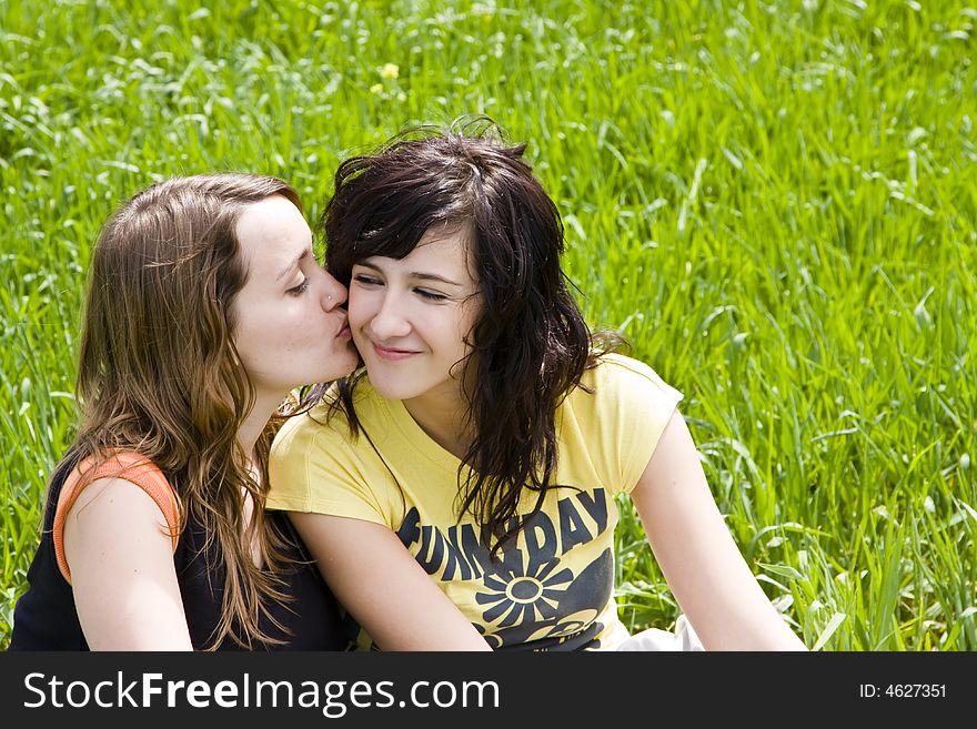 Friendly kiss betwen two young women. Friendly kiss betwen two young women