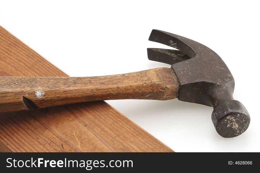 Old vintage wooden handle hammer and wood board. Old vintage wooden handle hammer and wood board