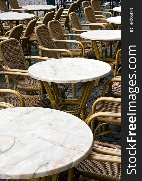 Tables with armchairs: small old-fashioned street cafe