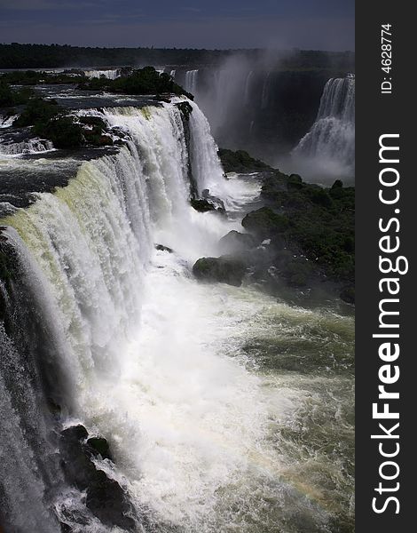 The Iguassu (or Iguazu) Falls is one of the largest masses of fresh water on the planet and divides, in South America, Brazil, Paraguay and Argentina. The waterfall system consists of 275 falls along 2.7 kilometres (1.67 miles) of the Iguazu River. Some of the individual falls are up to 82 metres (269 feet) in height, though the majority are about 64 metres (210 feet). The Iguassu (or Iguazu) Falls is one of the largest masses of fresh water on the planet and divides, in South America, Brazil, Paraguay and Argentina. The waterfall system consists of 275 falls along 2.7 kilometres (1.67 miles) of the Iguazu River. Some of the individual falls are up to 82 metres (269 feet) in height, though the majority are about 64 metres (210 feet).