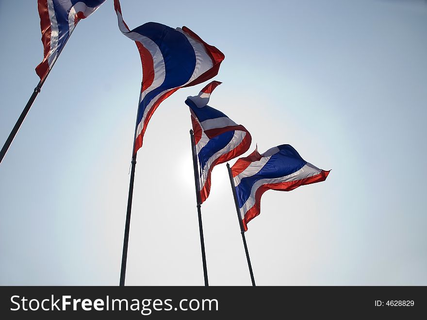 A series of Thai flags on a windy day