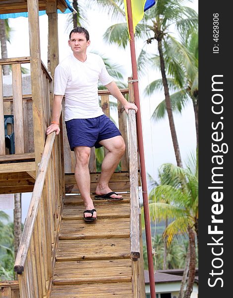 Beach instructor looking after order from wooden tower. Beach instructor looking after order from wooden tower