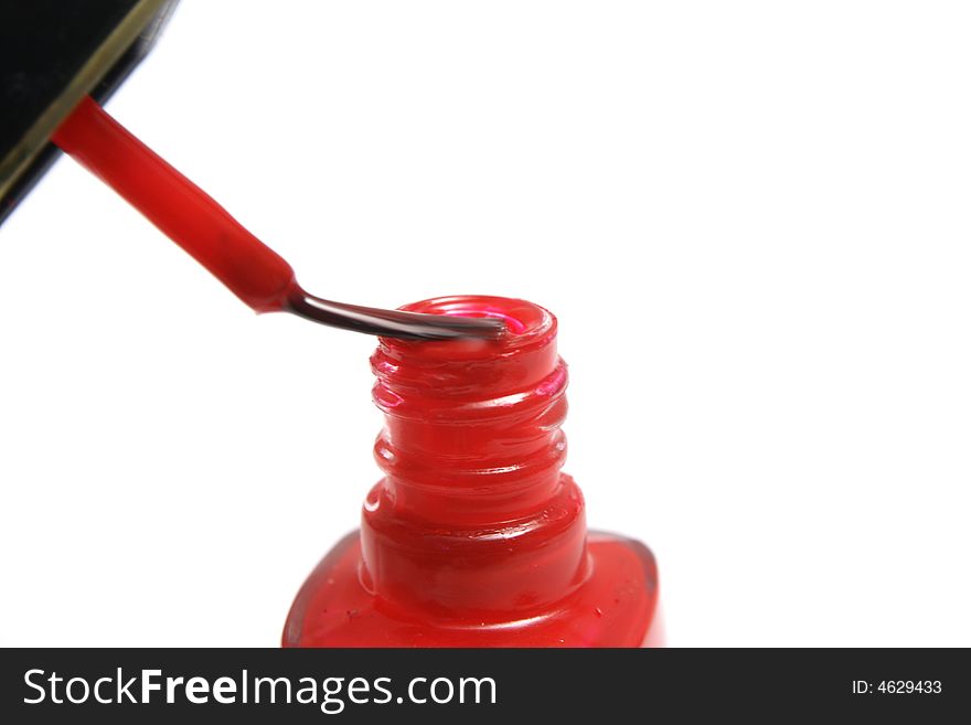 A brush and jar of red nail polish