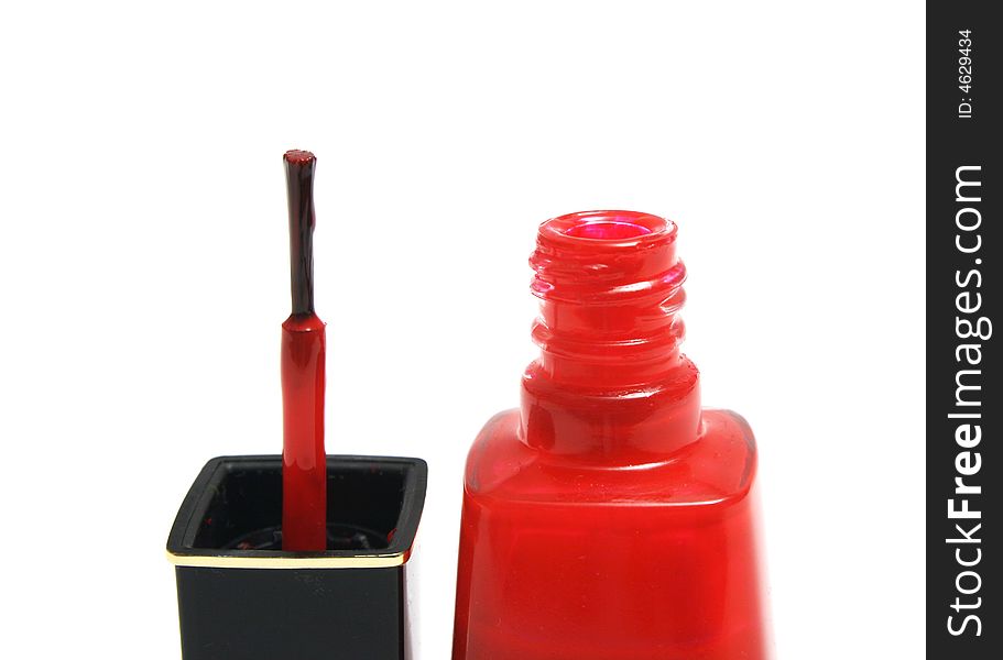 A brush and jar of red nail polish