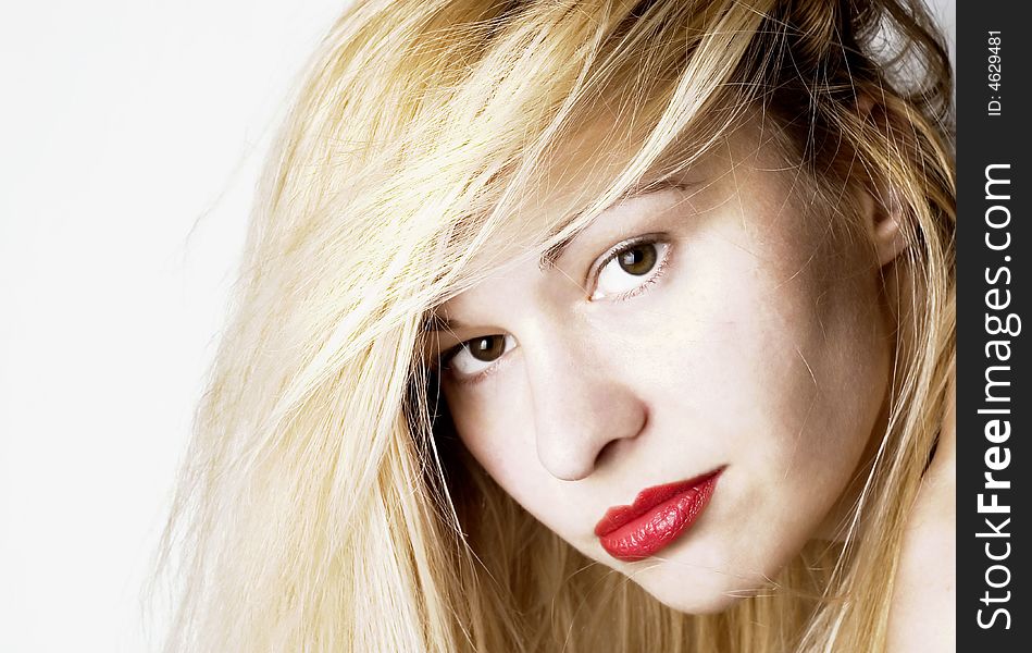 Beautiful young woman with headache holding her hand inpain. Red lips and nails. White background. Beautiful young woman with headache holding her hand inpain. Red lips and nails. White background.