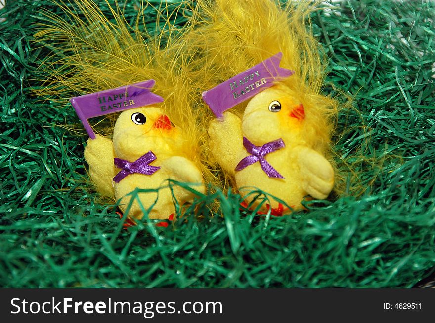 Two plastic easter chickens in the grass