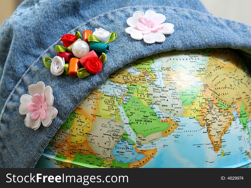 Globe in jeans hat with flower