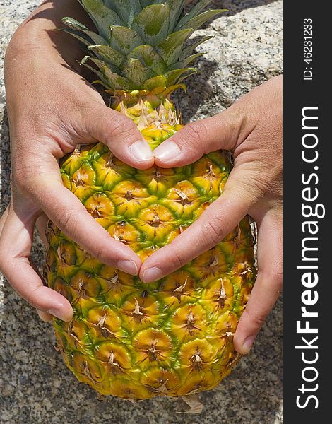 Thumbs form a heart on the pineapple. Concept like pineapples. Concept of love