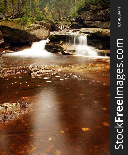 The water of a torrent flow between mountain rocks