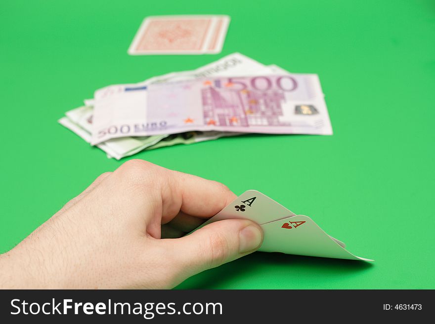 Poker cards vs euro money on green. Poker cards vs euro money on green