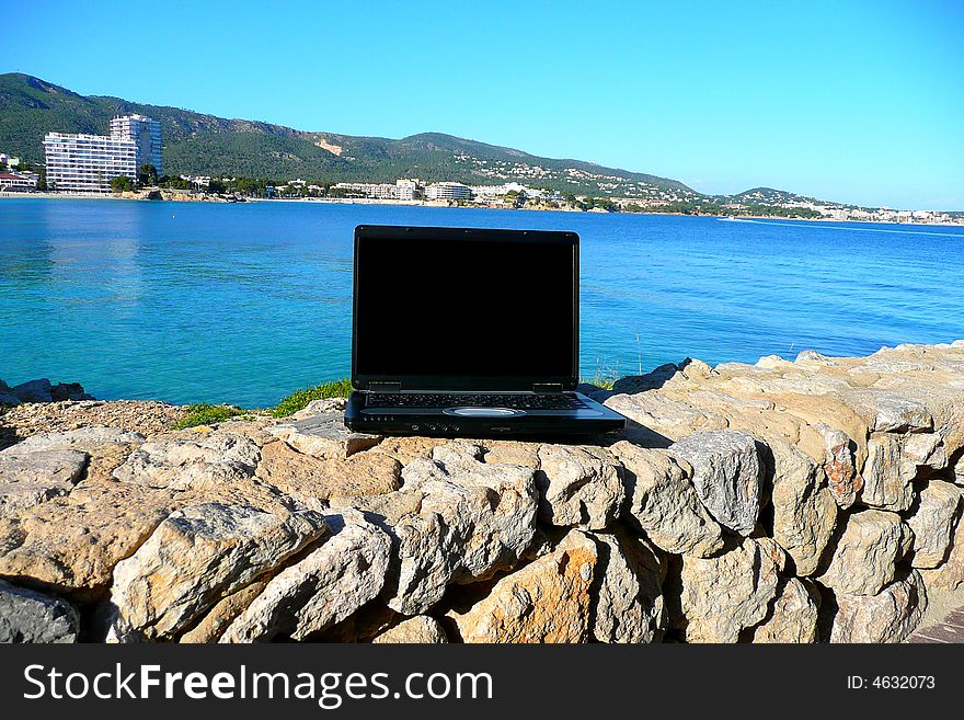 Laptop with sea view and blank screen for text. Laptop with sea view and blank screen for text