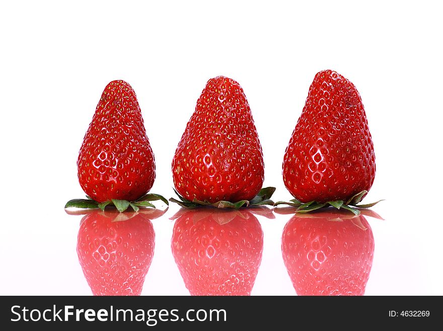 Three strawberries on white background