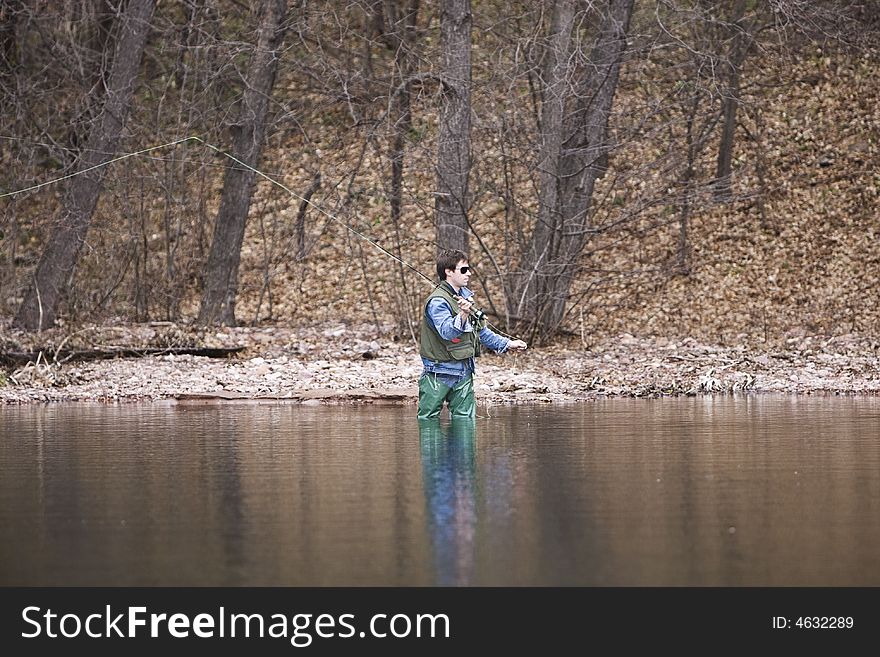 Fly fisher fishing in the river