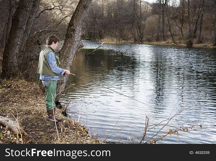 Fly fisher fishing by the river