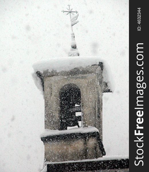The belltower of the churh of San Sebastiano in Monno, Italy, during  a snow fall in December 2003. The belltower of the churh of San Sebastiano in Monno, Italy, during  a snow fall in December 2003