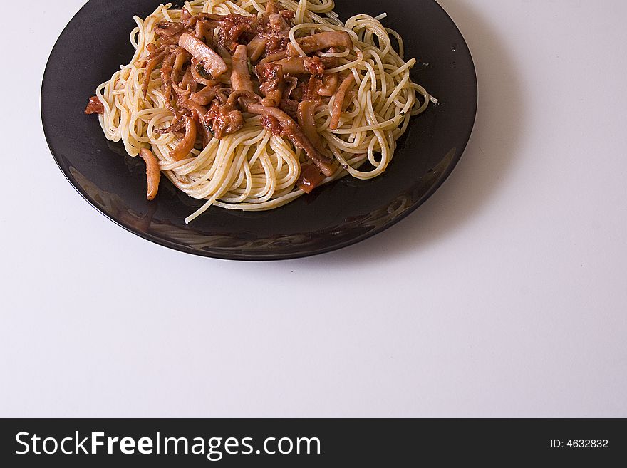 Flat typical Mediterranean to base of fish, spaghetti to the juice of tomato with squids. Flat typical Mediterranean to base of fish, spaghetti to the juice of tomato with squids