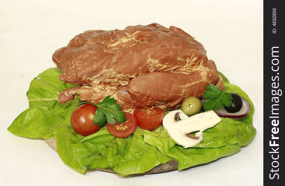 Cooked pork meat with salad and vegetable decoration