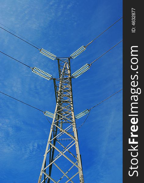 Modern high voltage power lines and blue sky.