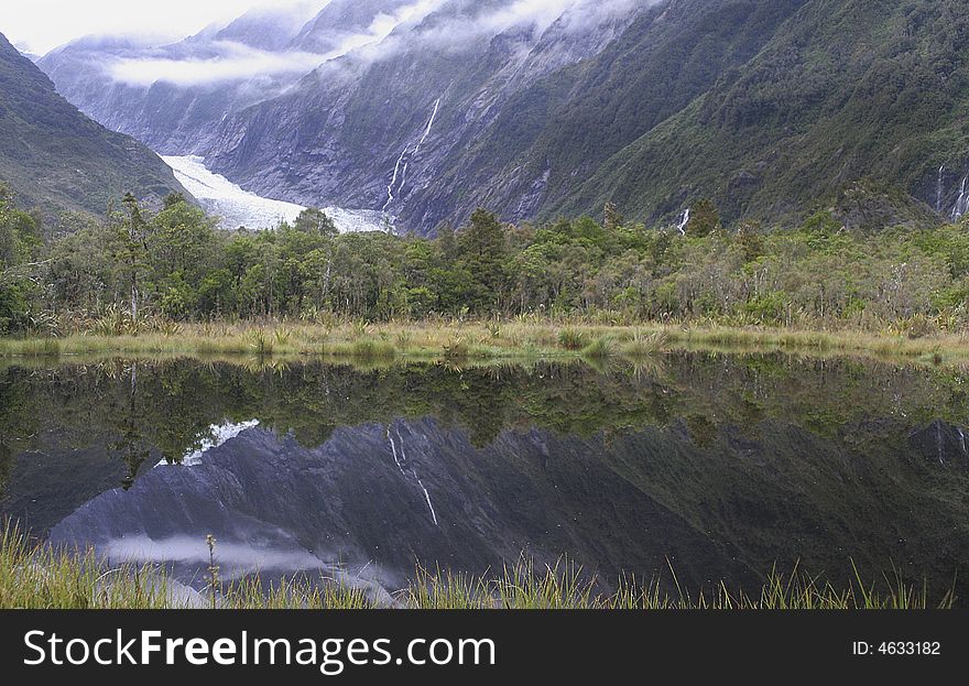 Douglas walkway,West Coast, South Island, New Zealand.The Douglas Walk is an easy forest walk that takes you over ancient glacial landforms formed between 1600 AD and 1750 AD. The return walk to the carpark is via the glacier access road taking 15 minutes.
 
The track starts on a river fan covered with 40-year-old shrub forest. Peters Pool viewpoint is about 10 minutes into the walk. Peters Pool is a kettle lake formed by melting buried ice about 1800 AD. The Franz Josef Glacier offers visitors a rare opportunity to experience a dynamic glacial environment, in a temperate environment, while being within easy driving and walking distance from the main highway. Douglas walkway,West Coast, South Island, New Zealand.The Douglas Walk is an easy forest walk that takes you over ancient glacial landforms formed between 1600 AD and 1750 AD. The return walk to the carpark is via the glacier access road taking 15 minutes.
 
The track starts on a river fan covered with 40-year-old shrub forest. Peters Pool viewpoint is about 10 minutes into the walk. Peters Pool is a kettle lake formed by melting buried ice about 1800 AD. The Franz Josef Glacier offers visitors a rare opportunity to experience a dynamic glacial environment, in a temperate environment, while being within easy driving and walking distance from the main highway.